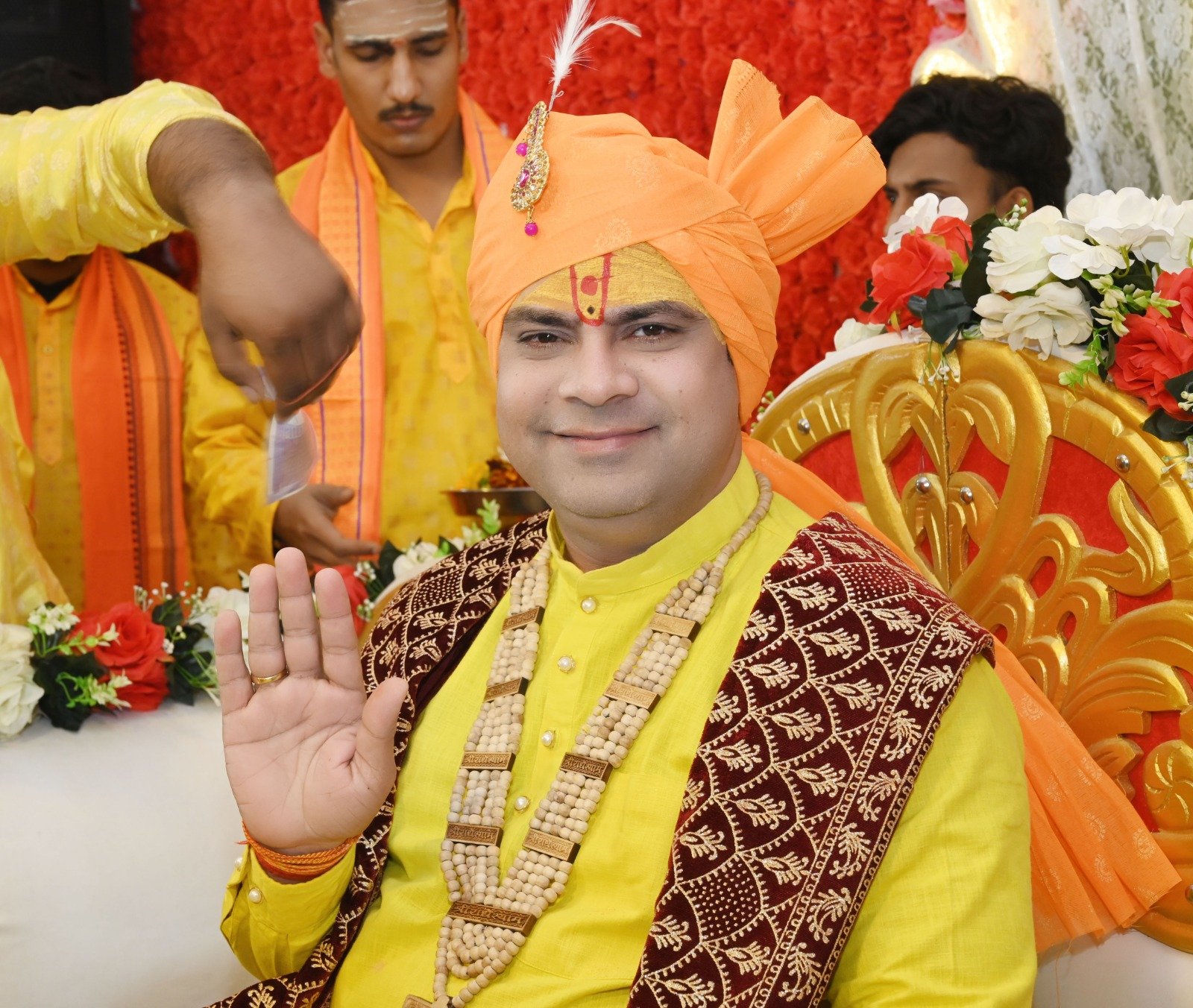 Acharya blessing devotees at a ceremony